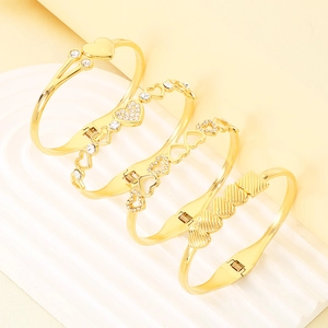 Set of four gold stainless steel heart bracelets featuring rhinestones on a wavy plate
