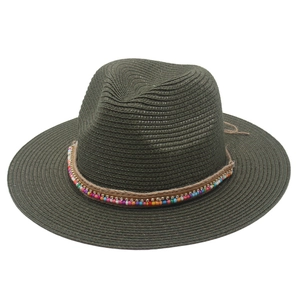 Close-up of deep green straw hat featuring bohemian colorful beads and rhinestone detail