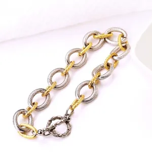 Two-tone textured link bracelet with silver and gold rings and an OT toggle clasp