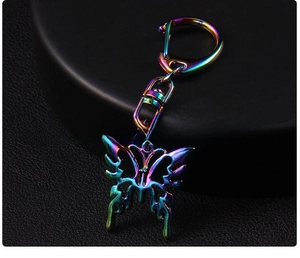 Macro shot of y2k butterfly keychain with iridescent plating and a large spring clasp