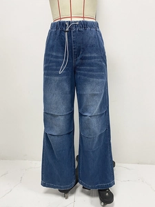 Detail view of elastic waist and drawstring design on wide-leg dark blue denim pants