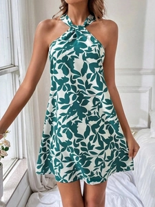 Close-up of green and white floral print halter dress with ruffled details and open back