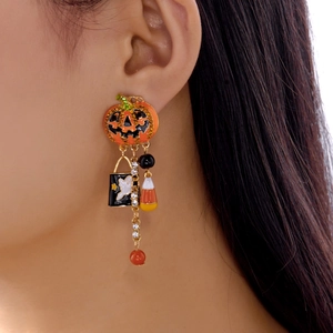 Detail of Halloween drop earrings with pumpkin and ghost motifs on a gold chain