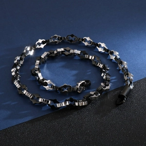 Macro shot of two-tone black and silver wave link chain necklace for men in hip hop style