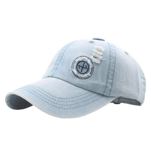 Vintage washed denim baseball cap with distressed details and round embroidered patch