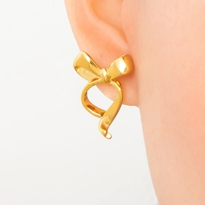 Elegant 18k gold plated stainless steel bow earrings worn as a close-up fashion shot