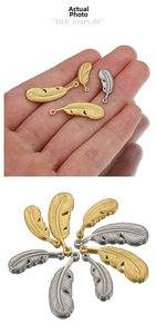 Detailed macro view showing gold and silver feather pendants in various sizes and textures
