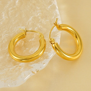 French vintage 18K gold plated stainless steel chunky hoop earrings on a glass plate