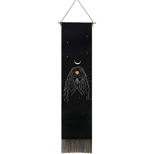 Black tapestry with white lines showing a praying girl under a golden sun and moon with tassels