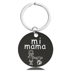 Detail of round black metal keychain with engraved mi mama text and mother daughter icon
