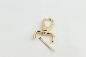 Detailed view of light gold metal swivel snap hook with removable screw bar for bags