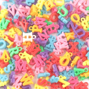 Detailed top view of colorful assorted plastic alphabet beads for DIY jewelry making