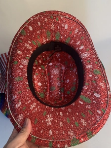 Detail view of red sequin party hat interior showing size 57 and polyester material label