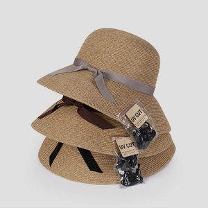 Three elegant wide brim straw sun hats with chic bow ribbons for UV protection and travel