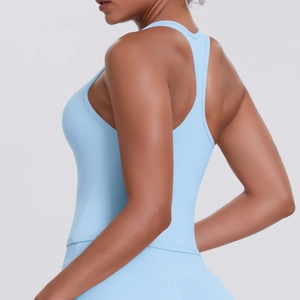 Close-up of racerback design on light blue yoga tank top showing fitness fit and fabric