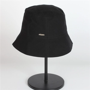 Women's UV protection black sun hat on display stand with minimalist metal emblem