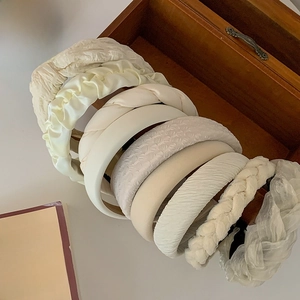 Elegant cream-colored headband set in velvet and satin styles for high cranial top look