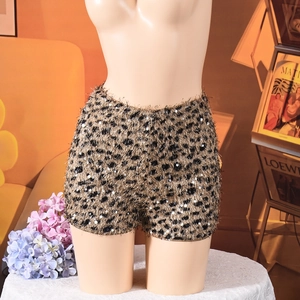 Macro shot of fuzzy leopard print shorts with reflective sequins and high waist design