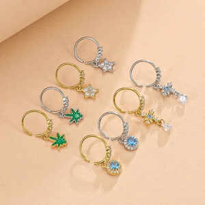 Detailed group view of gold and silver nose rings with star and leaf pendants