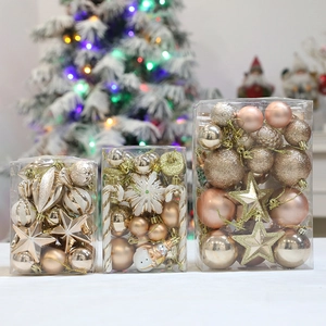 Christmas ornament set with gold and rose gold balls, stars and snowflakes in gift boxes