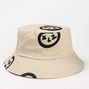 Close-up of beige cotton bucket hat featuring unique black graffiti letter patterns