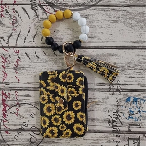 Detail of sunflower card holder with silicone bead wristlet and decorative tassel