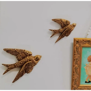Golden flying swallow wall decor with intricate feather textures for home living room