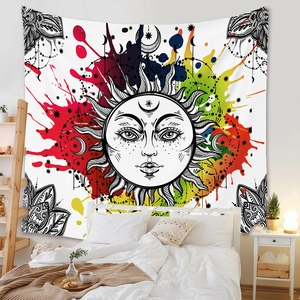 Detail of bohemian sun and moon tapestry featuring vibrant colorful ink splashes on a wall
