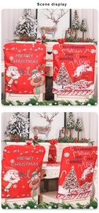 Close-up of festive Christmas chair covers and wine bottle sleeves with Santa motifs