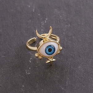 Detailed close-up of 18K gold evil eye ring with celestial star and moon accents