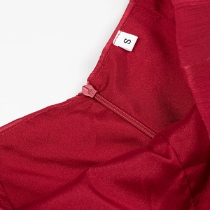 Detailed close-up of the red satin fabric texture with S-size label and invisible zipper