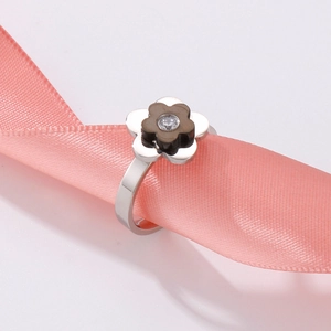 Minimalist flower ring in silver steel with dark petals and center zircon on pink silk