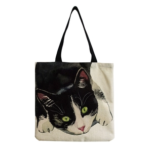 Cute beige canvas tote bag with black cat illustration and comfortable shoulder straps