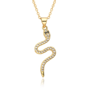 Close-up of gold snake pendant with sparkling crystals and black stone eyes