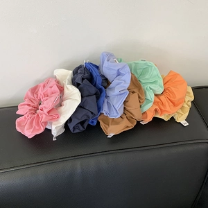 Colorful fabric scrunchie set including pink, blue, and yellow soft hair elastics