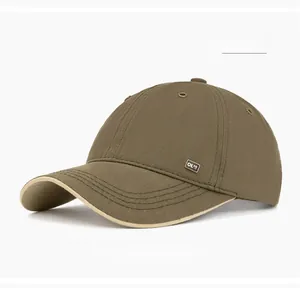 Detail of military green baseball cap featuring metal OK-50 logo and twill texture