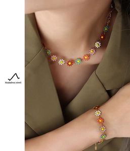 Detail of colorful daisy enamel jewelry set in stainless steel on a model