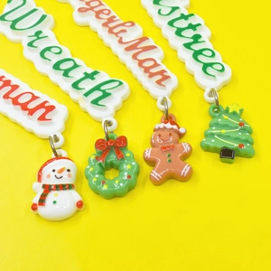 Close-up of resin Christmas pendants featuring snowman, wreath, gingerbread man, and tree