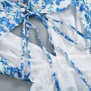 Close-up of floral dress details featuring adjustable back lace-up straps and stitching