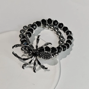 Detailed close-up of a Gothic spider charm bracelet with black beads and silver accents