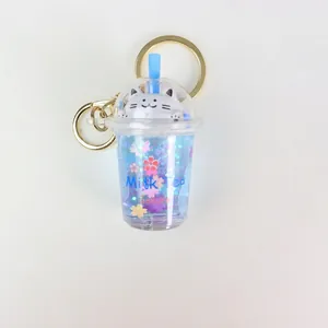 Blue cat bubble milk tea keychain with floating sakura glitter and gold metal ring