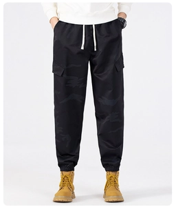 Detail view of men's dark camouflage cargo joggers with drawstring and side pockets