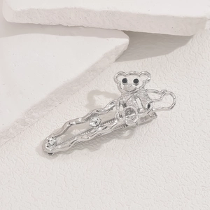 Detail of silver alloy hair clip featuring a bear motif and sparkling rhinestones