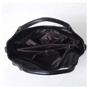 Internal view of black leather handbag featuring multiple zip pockets and a brown lining