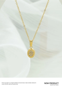 Detailed view of gold titanium steel oval pendant necklace with inlaid zircon stones