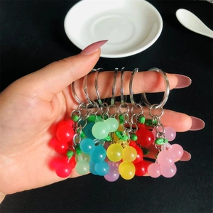 Luminous resin cherry keychains in multiple colors held for size and detail display