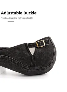 Close-up of adjustable gold buckle on dark grey denim flat cap for custom size fit