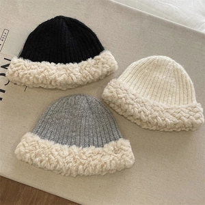 Three plush knitted bucket hats in black, white, and grey for autumn and winter warmth