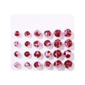 Spooky blood-stained pearl earrings set with 24 red speckled studs for Christmas parties