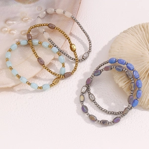 Detail of 18K gold plated beaded bracelets with natural stones and sea shells
